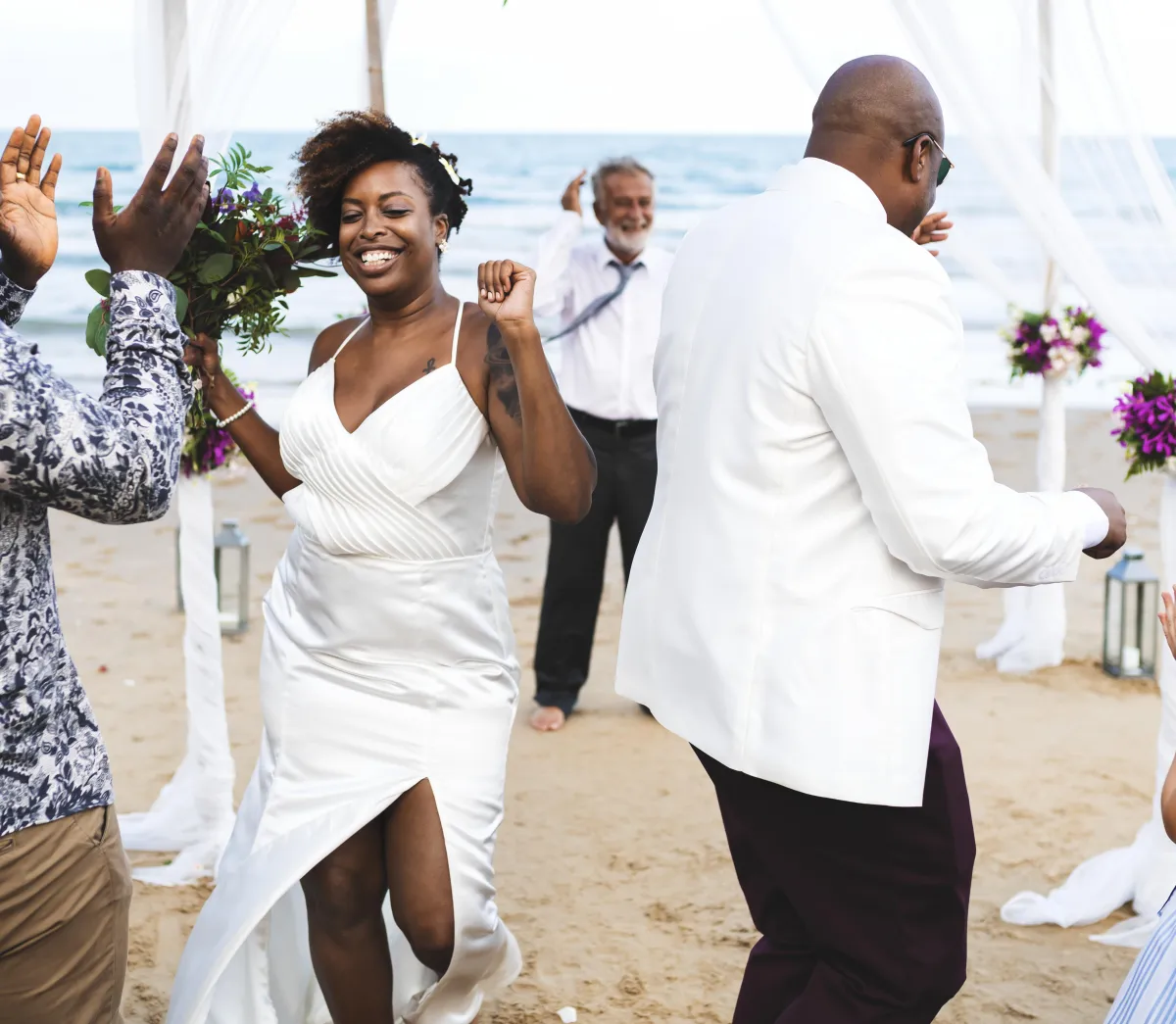 Bride and groom dancing under the open sky at a stunning Dallas outdoor wedding venue, with a picturesque floral arch and scenic Texas backdrop.