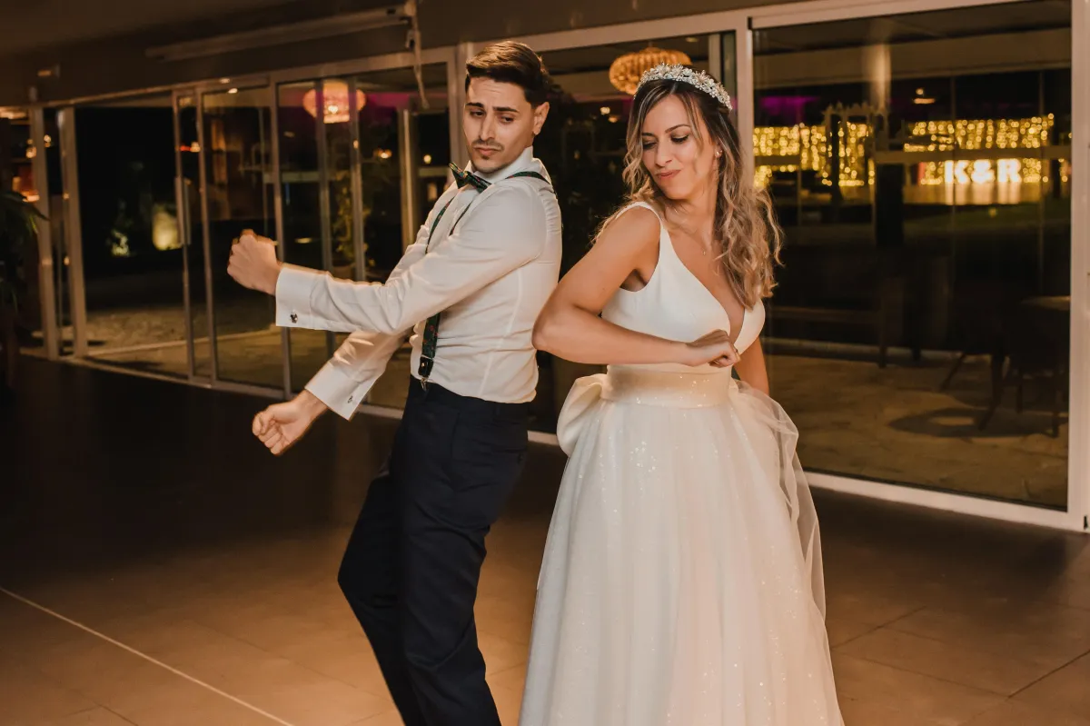 Bride and groom dancing together at an elegant wedding reception - Dynamic Celebrations DJ services in College Station.