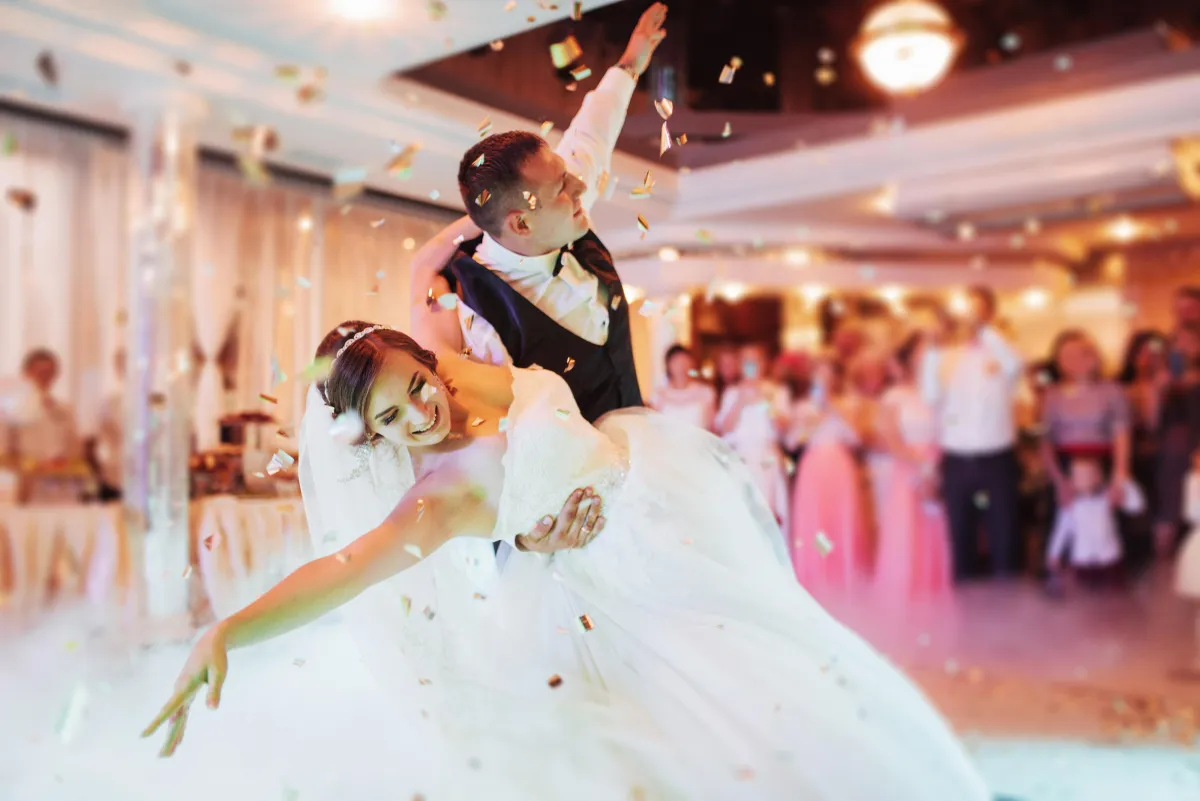 Elegant first dance moment with confetti and low-lying fog at a wedding reception - Best wedding DJs in College Station.