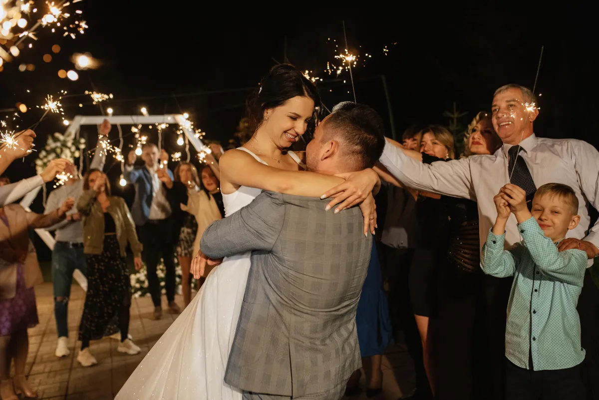 Bride and groom dancing under sparklers at a luxury wedding reception - Dynamic Celebrations DJ services in San Antonio.