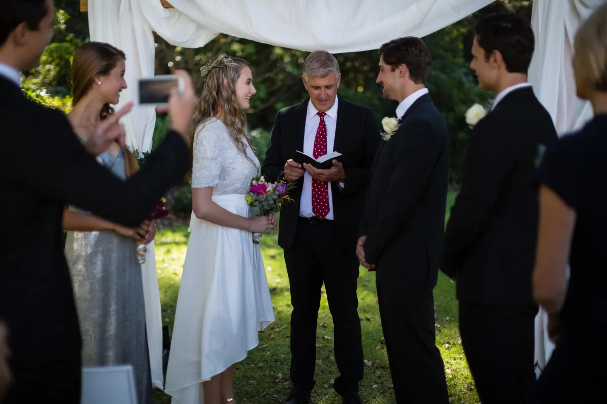 Wedding officiant leading a heartfelt ceremony in an outdoor setting for a couple in Houston, Dallas, Austin, or San Antonio.