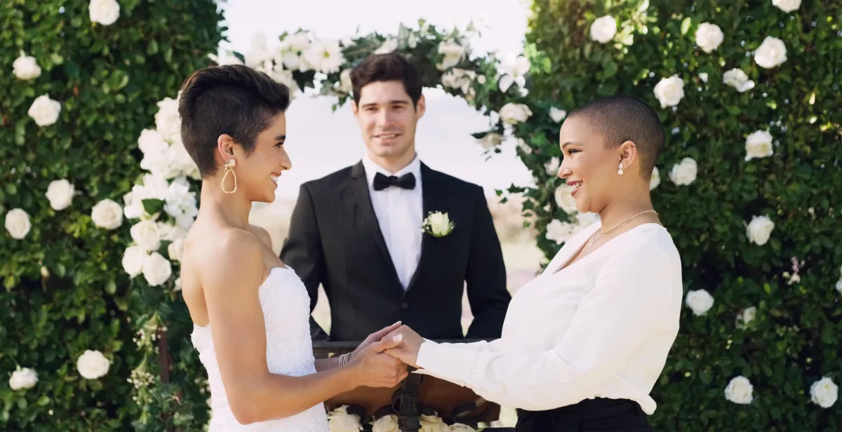 Couple holding hands and sharing their vows at a same-sex wedding ceremony officiated in Houston, Dallas, Austin, or San Antonio.