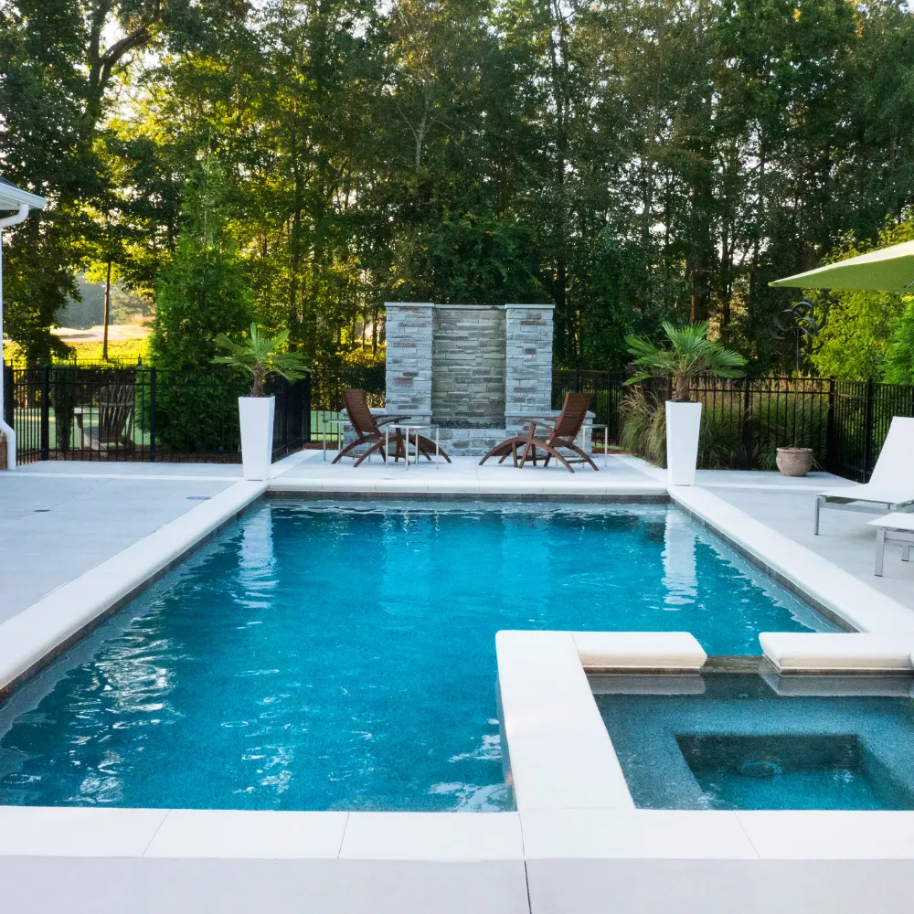Custom swimming pool with integrated spa and modern outdoor living space built by Miami Builders.