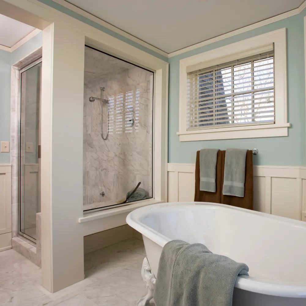 Luxury bathroom remodeling with a freestanding soaking tub, walk in shower, and custom finishes by Miami Builders.
