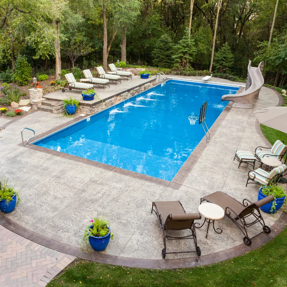 Luxury custom pool with spacious pool deck designed for outdoor entertaining by Miami Builders.