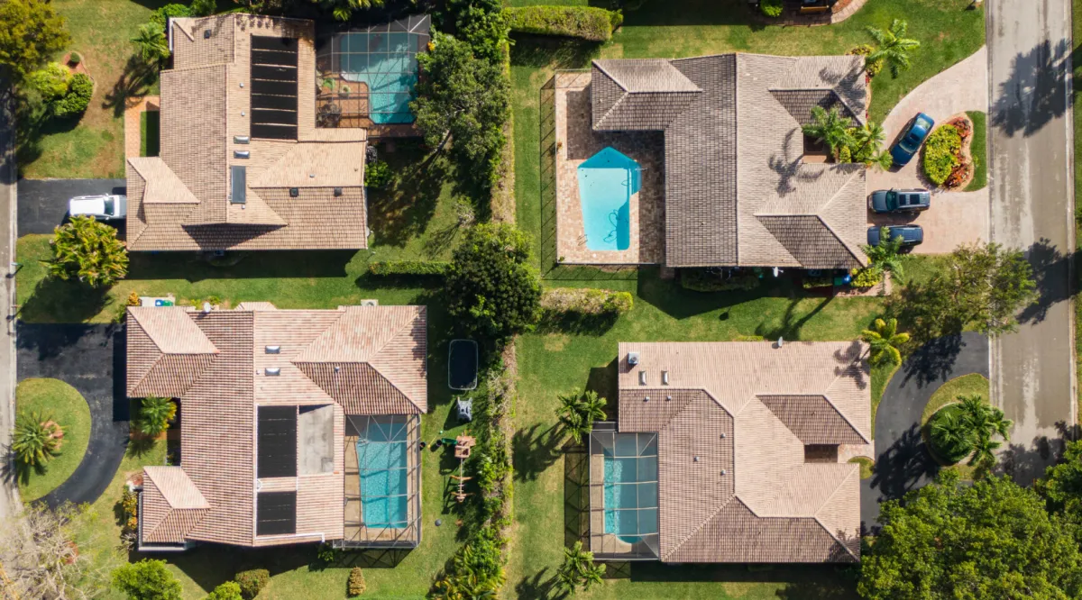 Aerial view of luxury homes showcasing custom pools, quality roofing, and expert residential construction by Miami Builders.