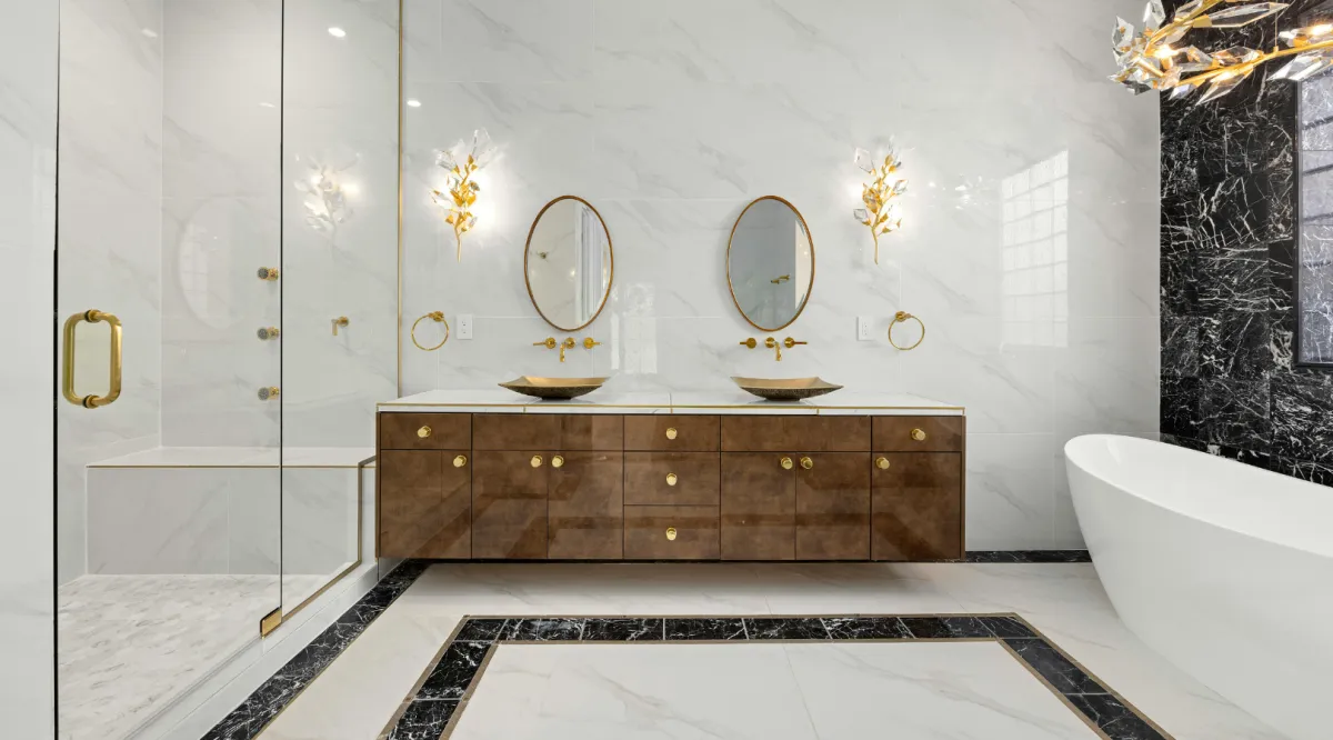 Luxury bathroom remodeling with a freestanding soaking tub, custom double vanity, marble tile, and frameless glass shower by Miami Builders.