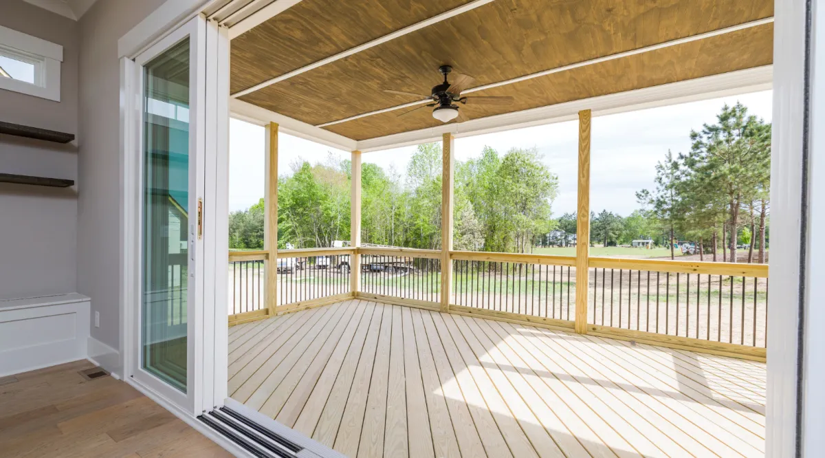Custom composite deck with covered patio, ceiling fan, and spacious outdoor living area built by Miami Builders.