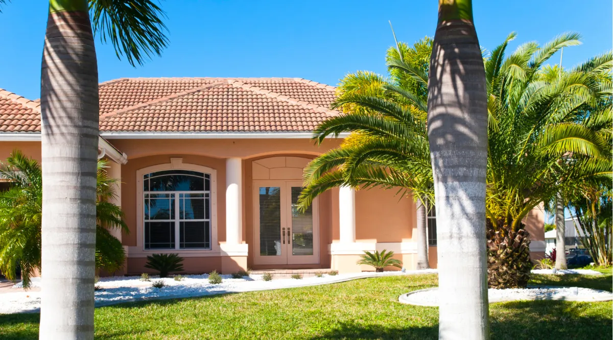 Beautiful home exterior renovation featuring updated stucco, tile roofing, and enhanced curb appeal by Miami Builders.