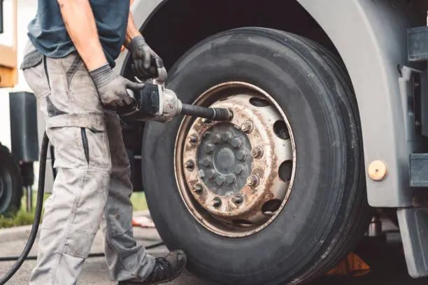 man performing mobile commercial tire repair