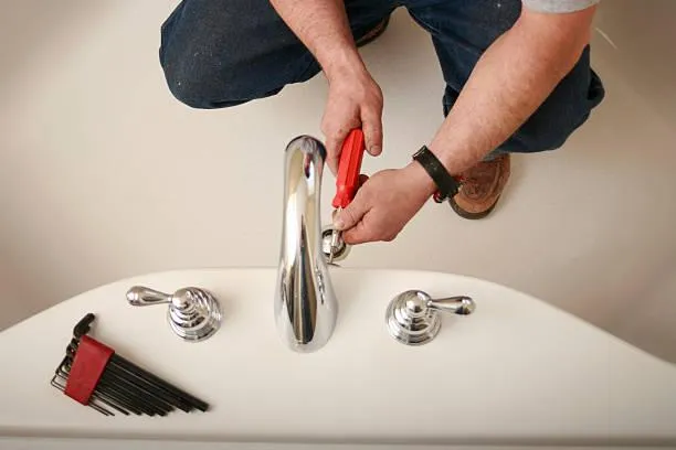 a brass faucet on a wooden table