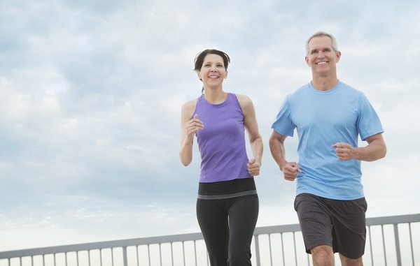 Couple jogging outdoors representing healthy lifestyle