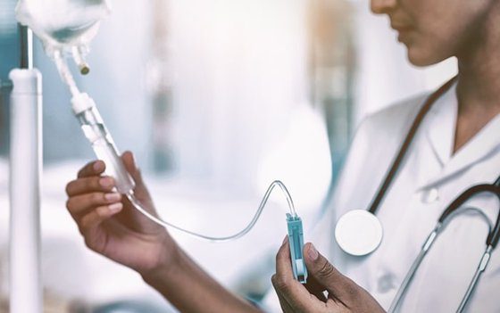 Close-up of hands preparing an IV drip or injection.
