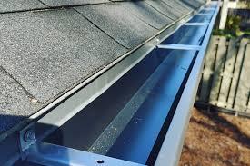 two men working on the roof of a house
