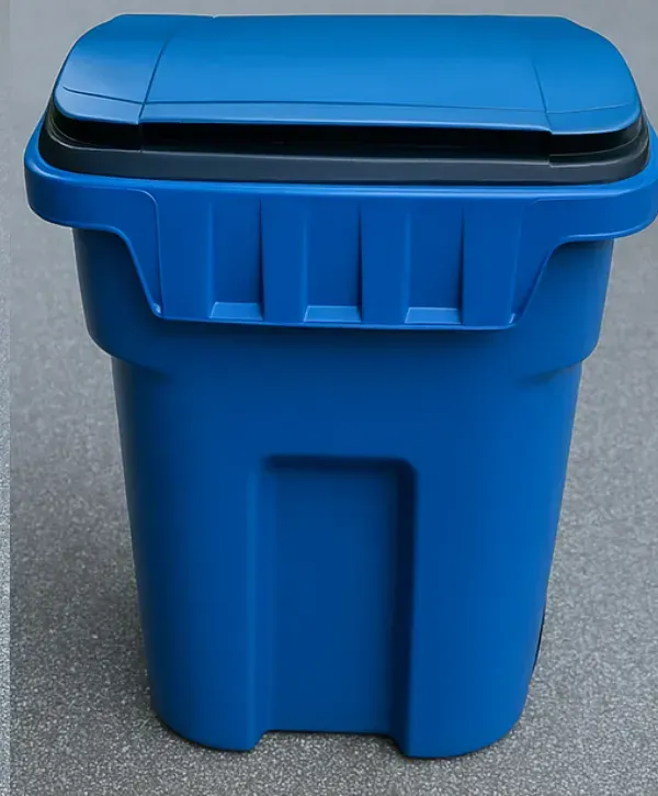 Clean blue trash bin with closed lid standing on pavement