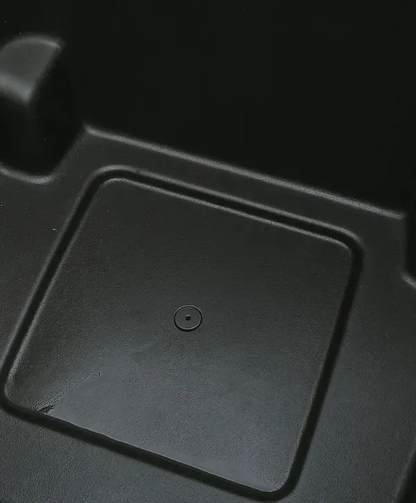 Close-up of a clean black trash bin bottom after pressure washing