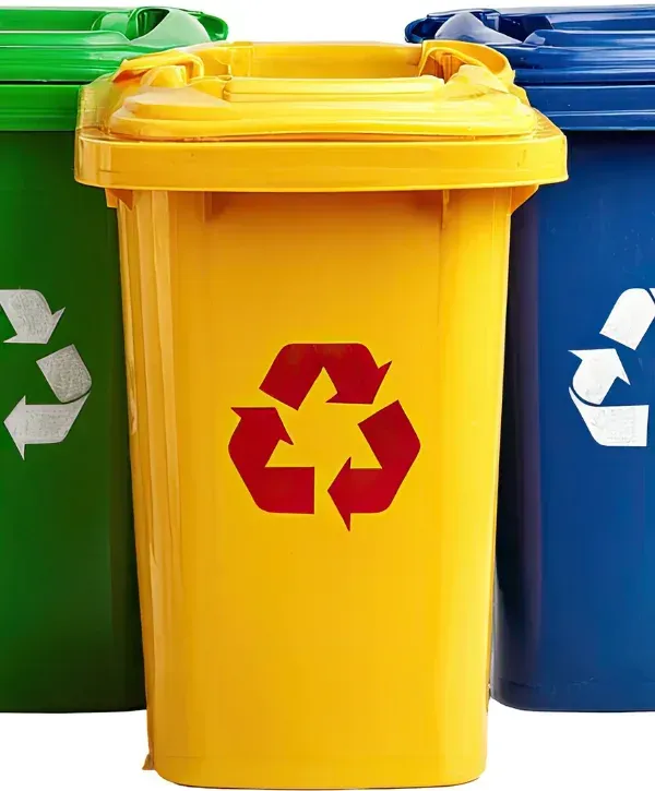 Green, yellow, and blue recycling bins with recycle symbols.