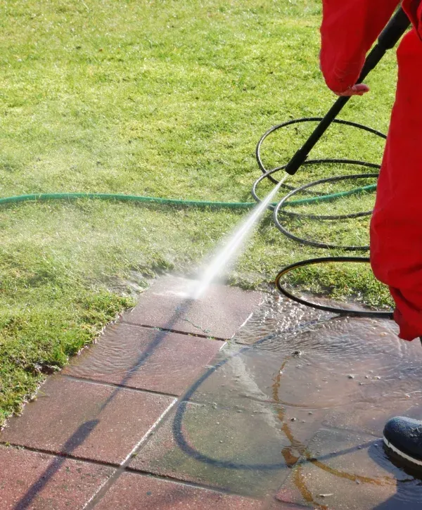 Professional pressure washing service cleaning residential walkway