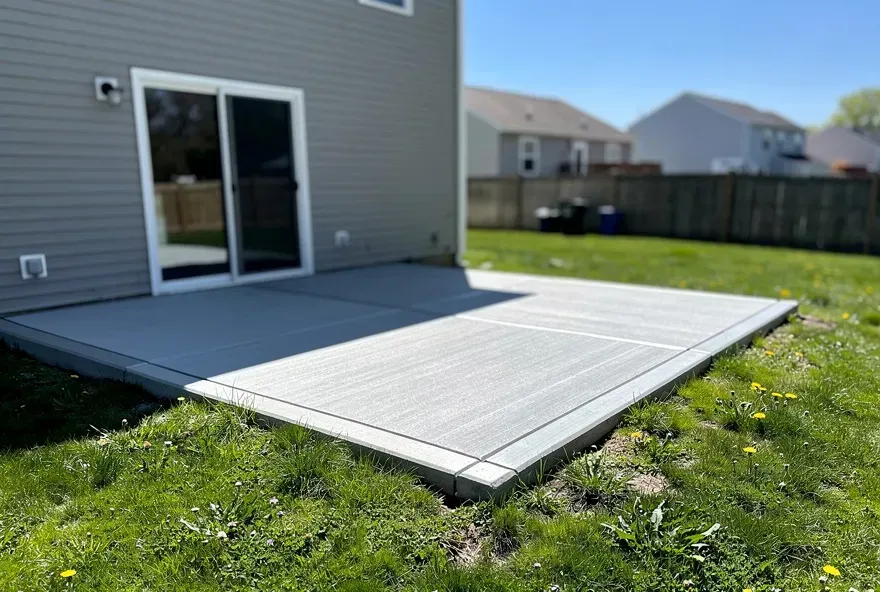 Freshly finished concrete patio attached to a modest home in North Tonawanda, New York