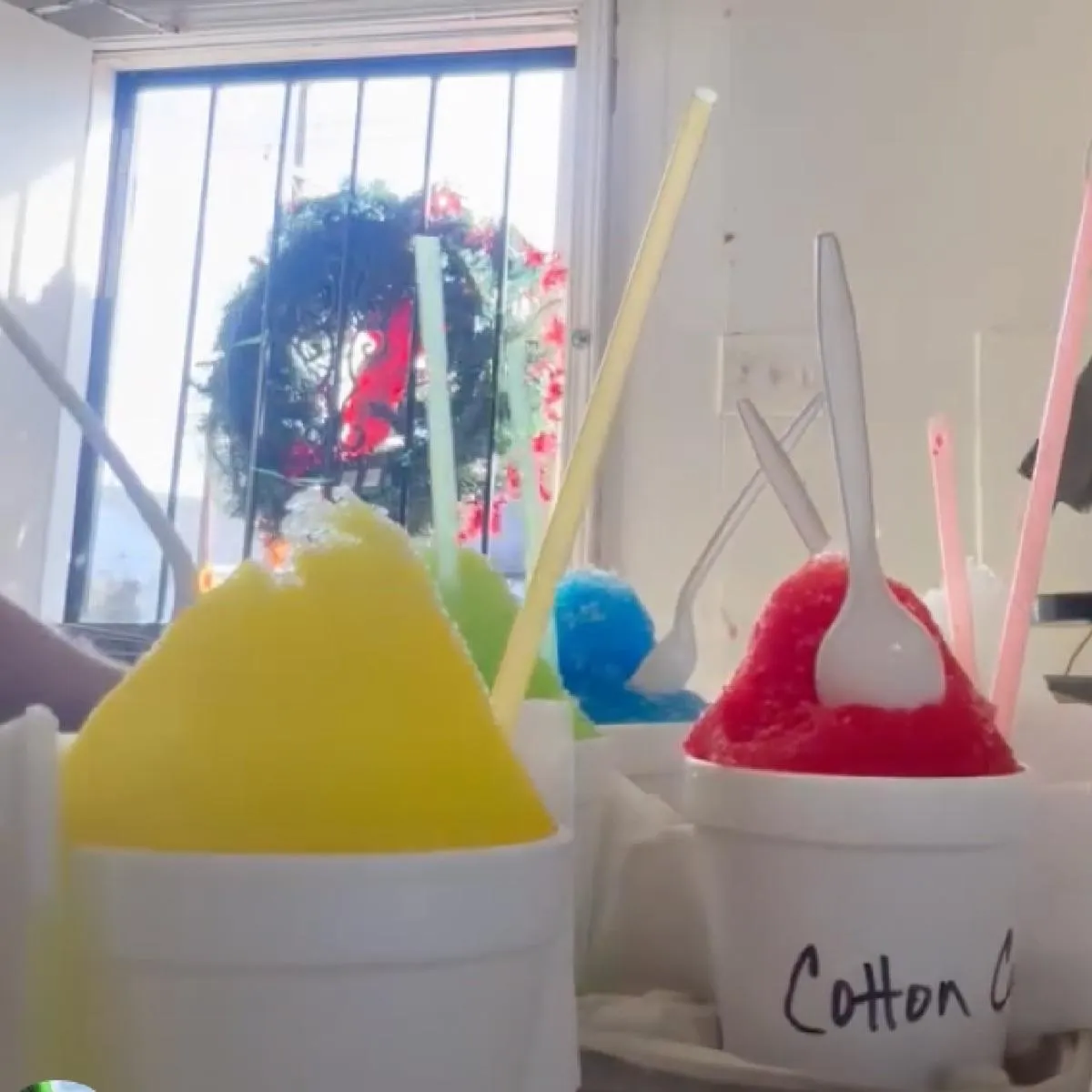 A plate of lemon snowball desserts dusted with powdered sugar, garnished with mint and seasonal fruit.
