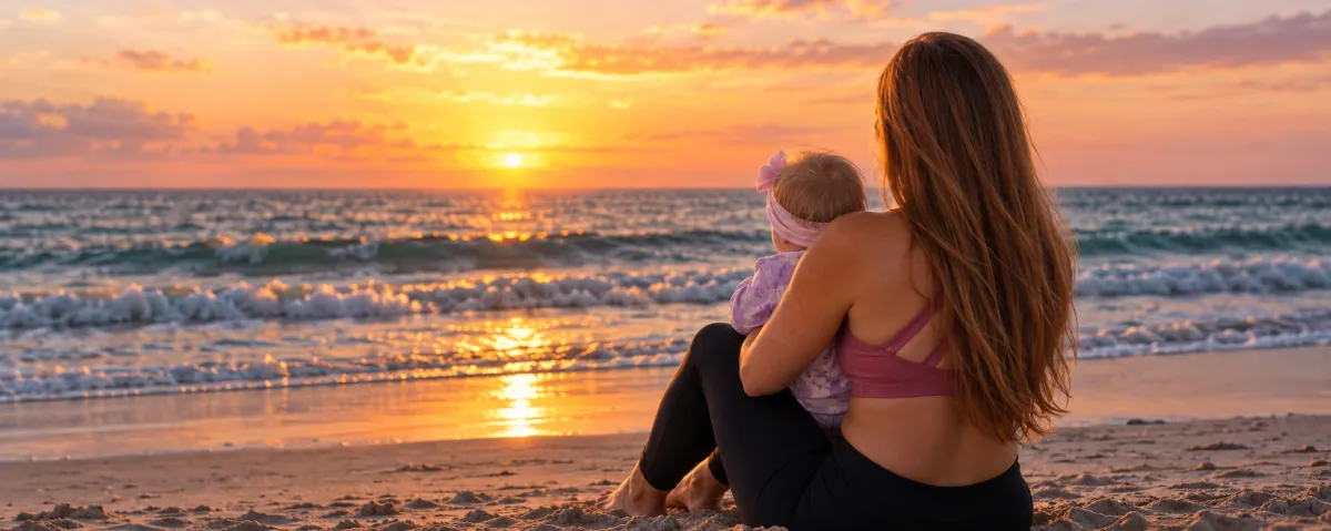 Crystal Pergola smiling in activewear holding her baby