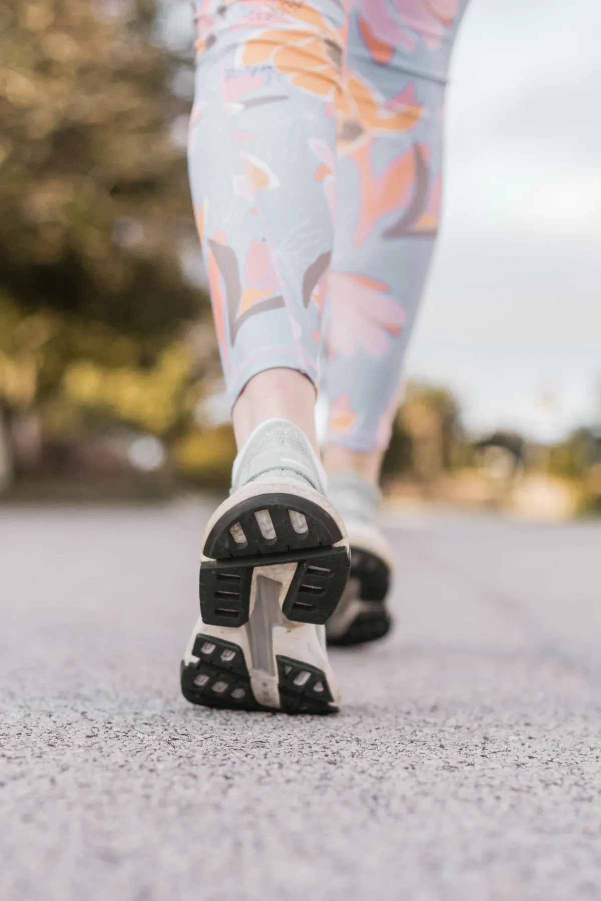 Close-up of a person's feet and legs walking, illustrating gait and stride analysis