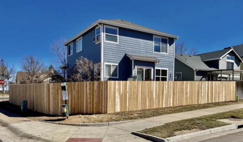 home with a brand new fence around it 