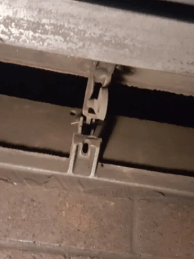 Close-up of a technician repairing a chimney damper mechanism