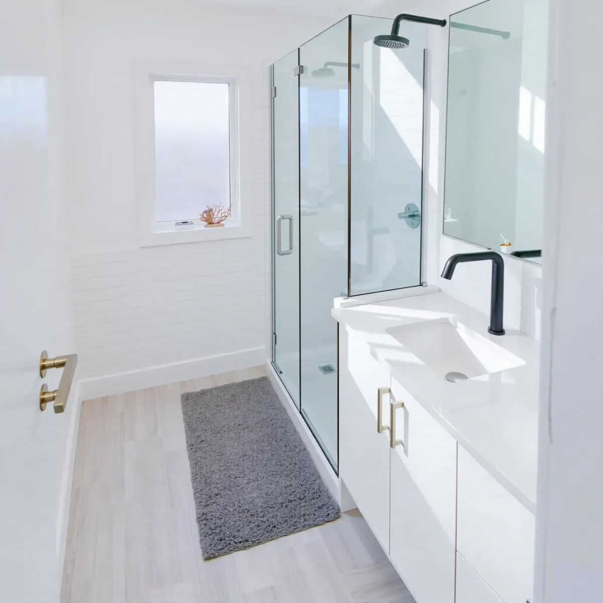 Remodeled Playa del Rey bathroom with walk-in shower, subway tiles, marble vanity, coastal accents, and natural light.