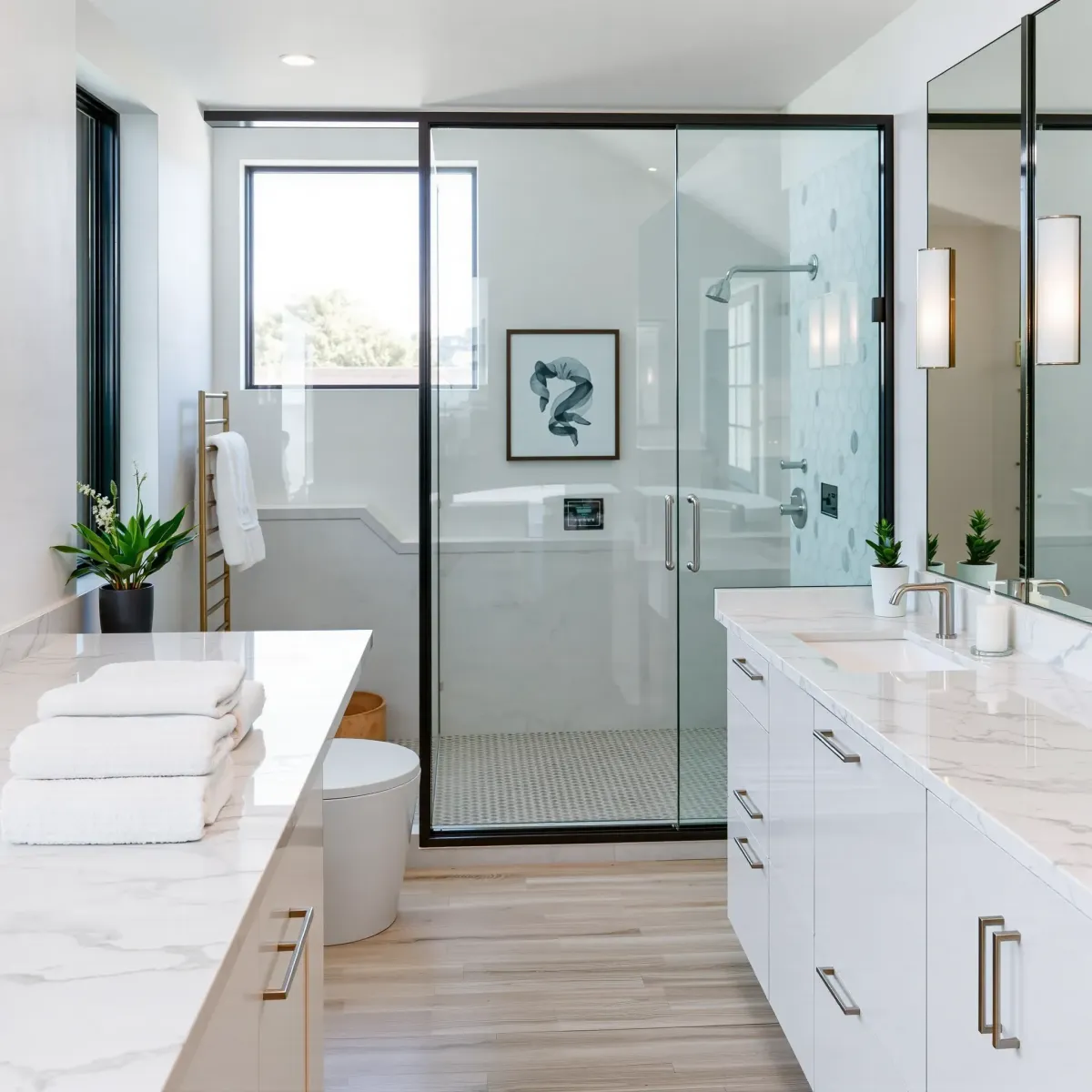 Remodeled Baldwin Hills bathroom with marble counters, glass shower, soaking tub, and modern elegant fixtures.