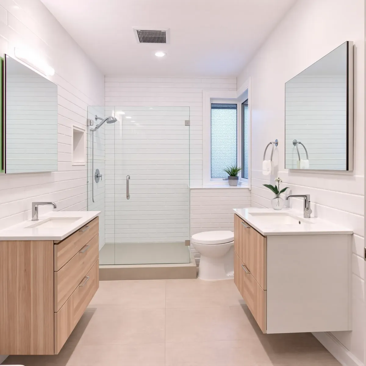 Modern small bathroom in Lomita, CA featuring sleek fixtures, white tiles, marble vanity, glass shower, and premium details.