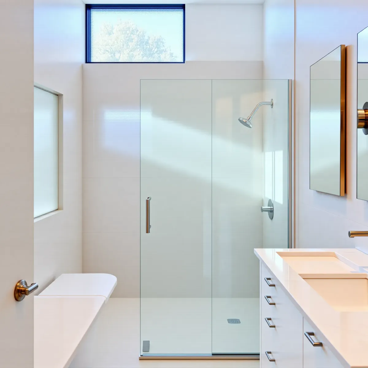 Renovated small bathroom in Hyde Park, CA with modern fixtures, marble vanity, neutral tiles, and natural lighting.