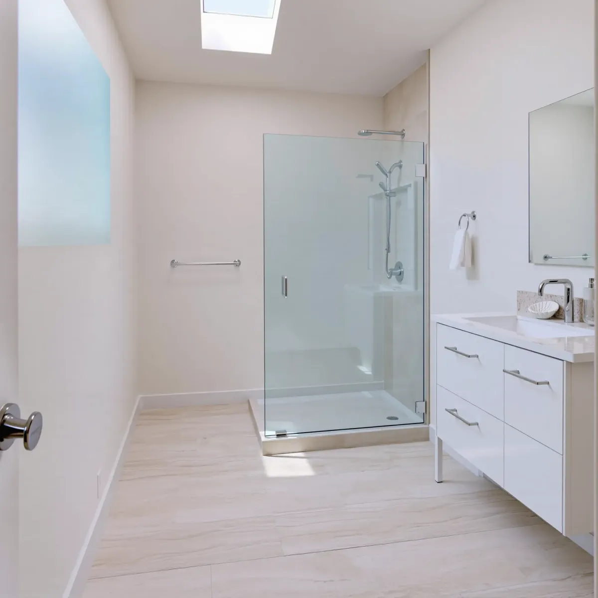 Remodeled Redondo Beach bathroom with modern fixtures, marble vanity, beach-inspired tile, and coastal coastal charm.