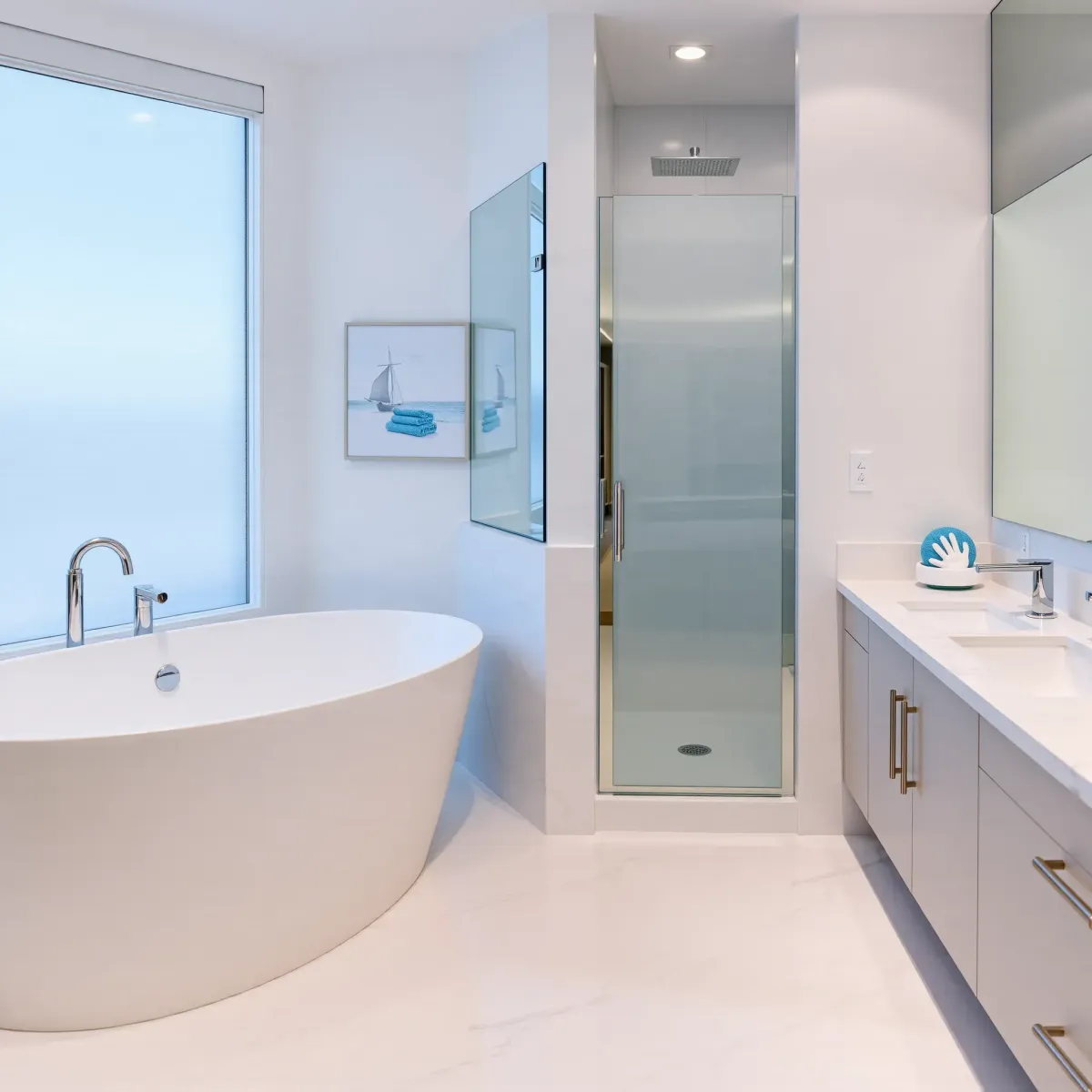 Modern Marina del Rey bathroom with large windows, marble vanity, walk-in shower, soaking tub, and scenic marina views.