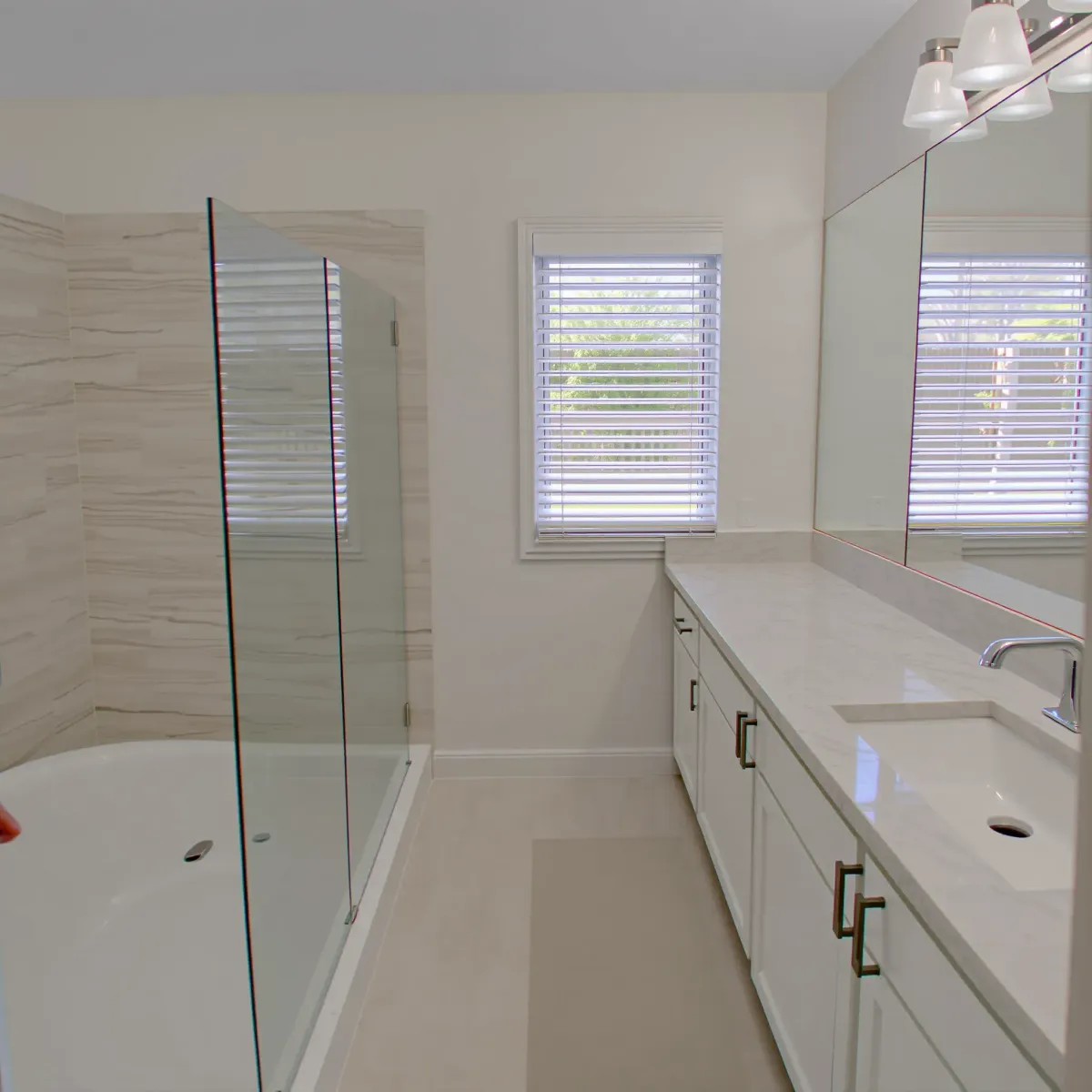 Modern bathroom remodel in Harvard Heights, CA with sleek fixtures, elegant tile, and stylish lighting.