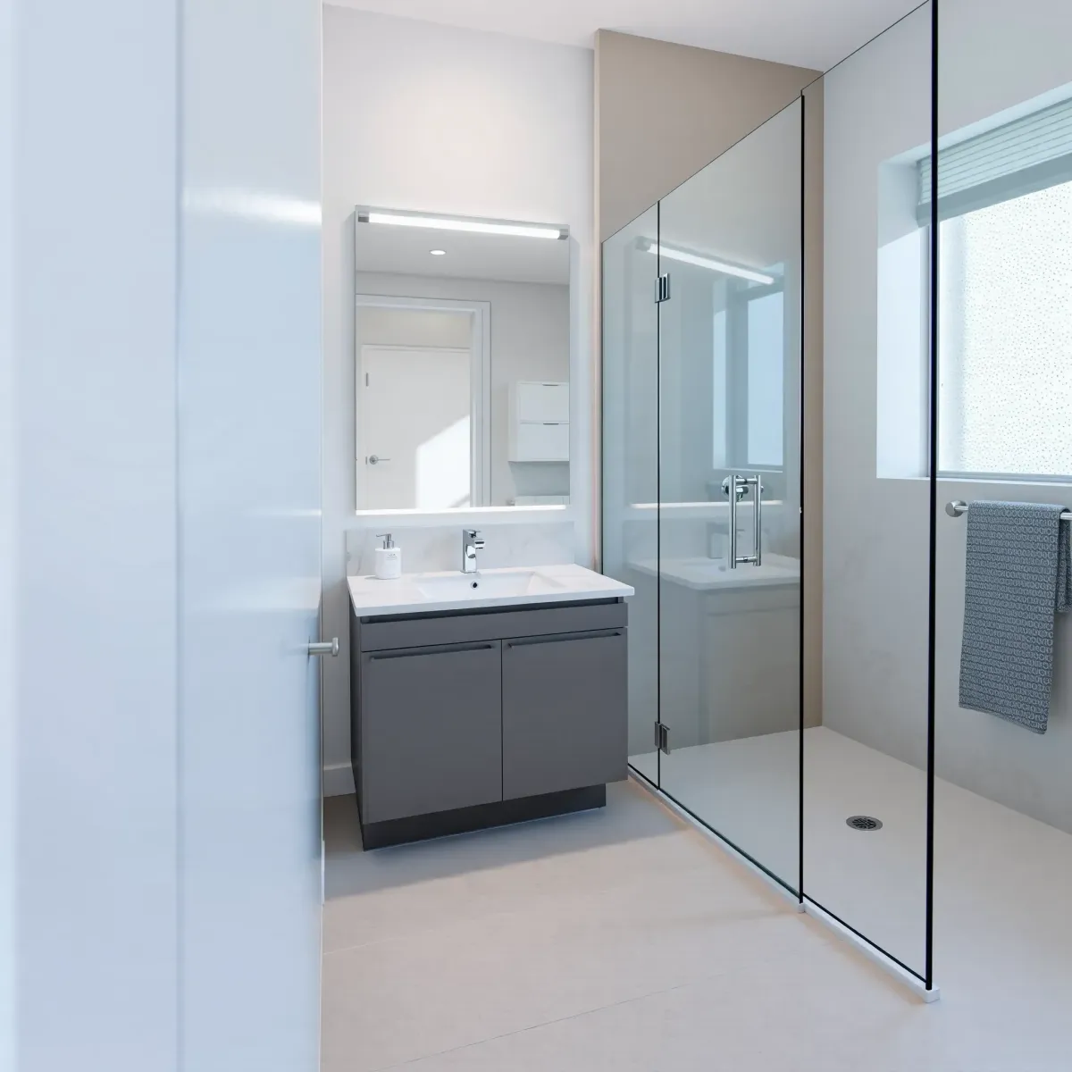 Renovated small bathroom in Palms, CA, with sleek fixtures, neutral tones, glass shower, marble countertop, and modern lighting.