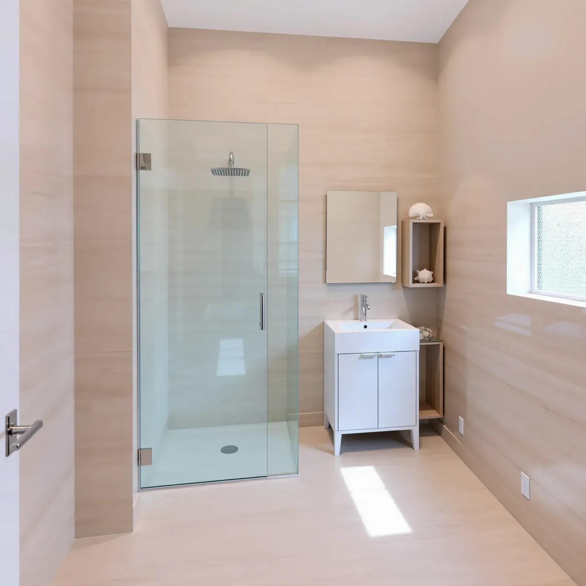 Recently remodeled small bathroom in El Segundo, CA featuring modern fixtures, marble countertop, glass shower, and stylish design.