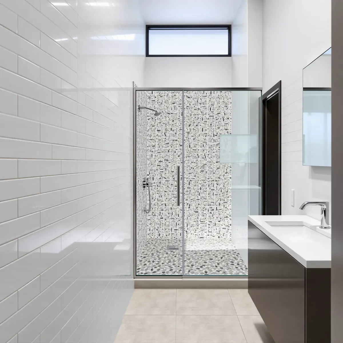 Remodeled small bathroom in South LA with white subway tiles, glass shower, pebble floor, quartz vanity, and modern accents.