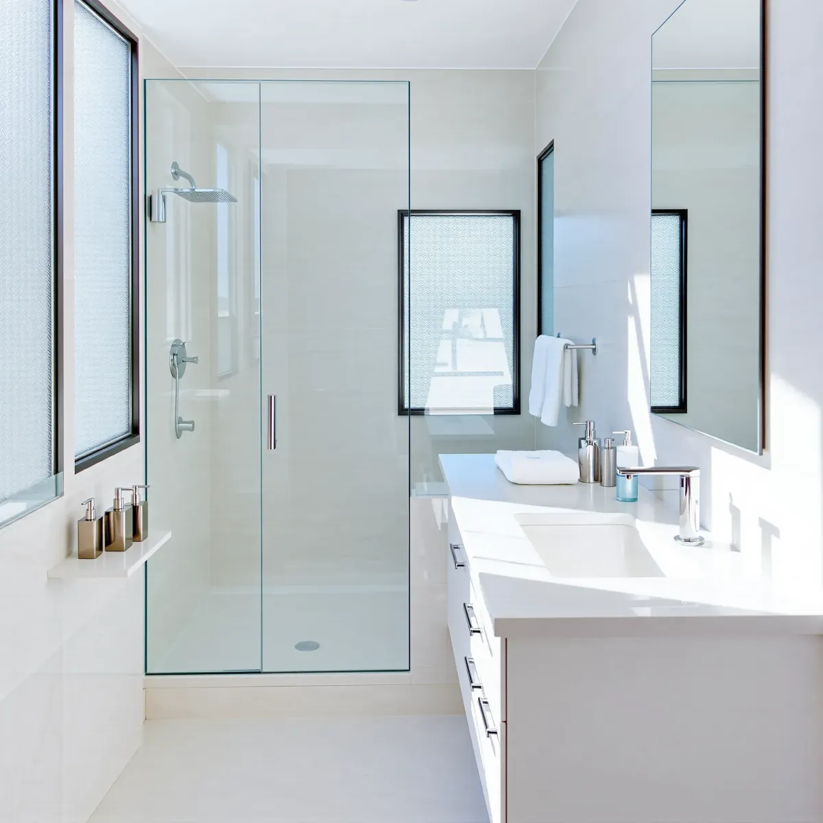 Small coastal-inspired bathroom in El Segundo with subway tiles, glass shower, floating vanity, and ocean decor.