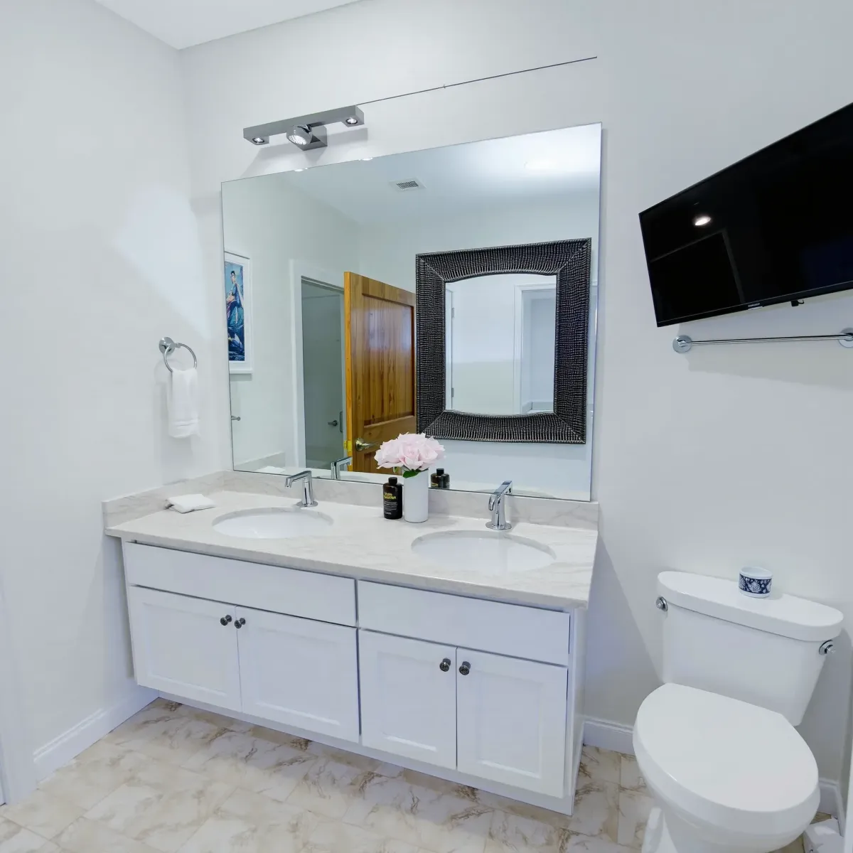 Beautiful Marina del Rey bathroom with sleek fixtures, glass shower, soaking tub, marble surfaces, and elegant gold accents.