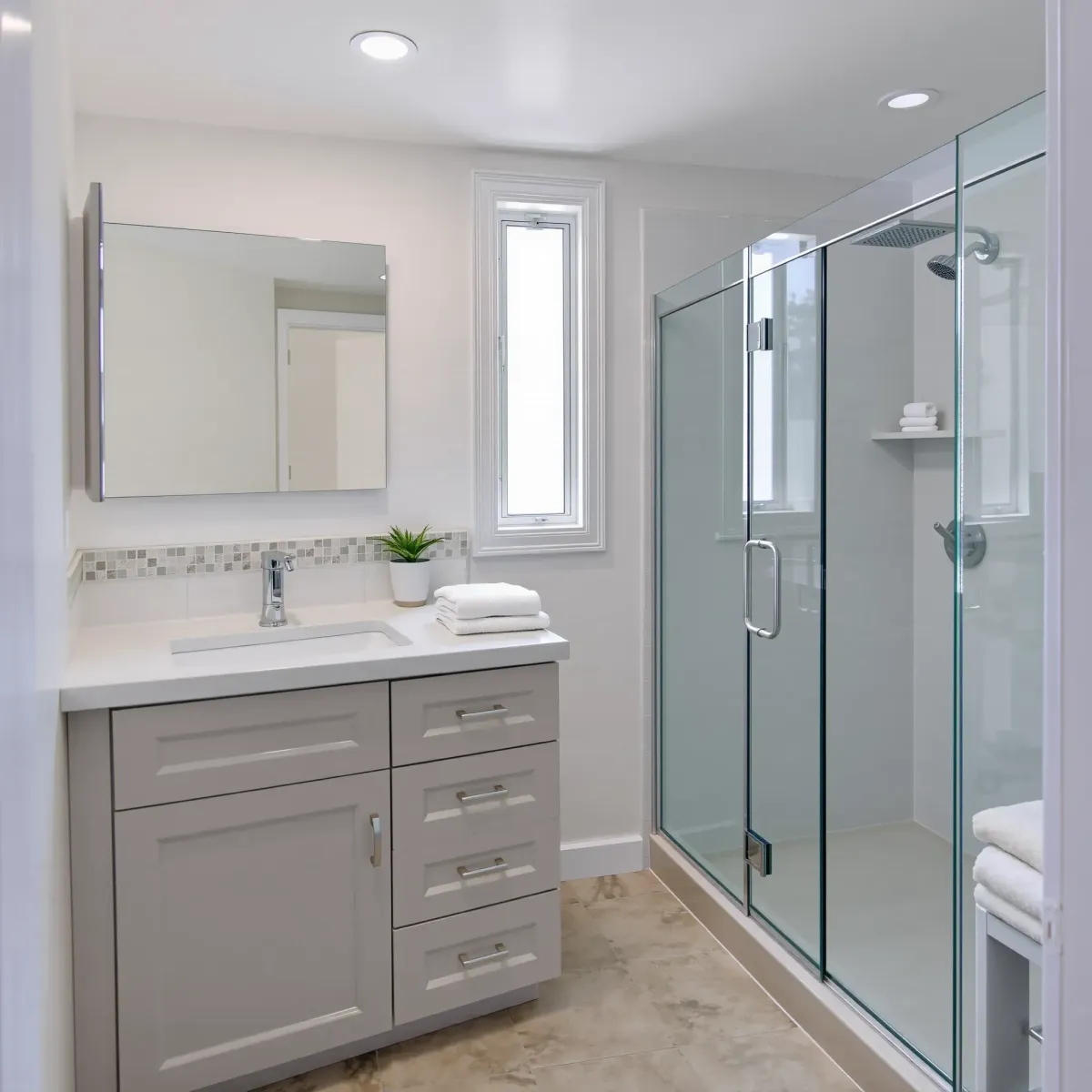 Modern small bathroom in El Segundo with floating vanity, marble countertop, walk-in shower, and coastal nautical accents.