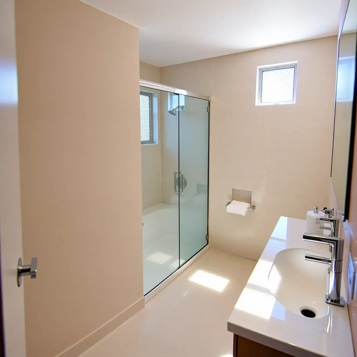 Renovated small bathroom in Lawndale, CA with walk-in shower, matte black fixtures, floating vanity, and natural light.