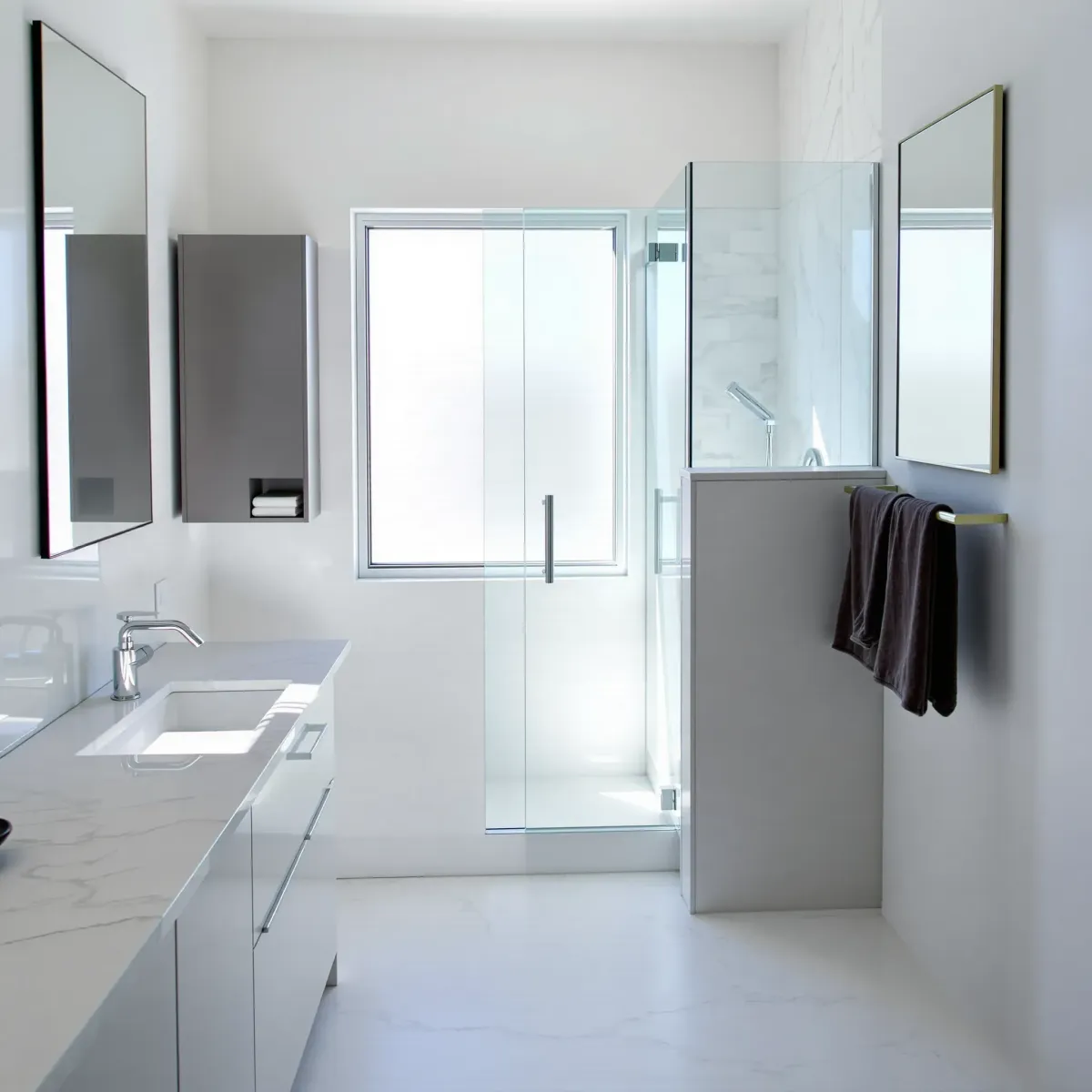 Remodeled small Windsor Hills bathroom with marble countertops, glass shower, chrome fixtures, and modern decor.