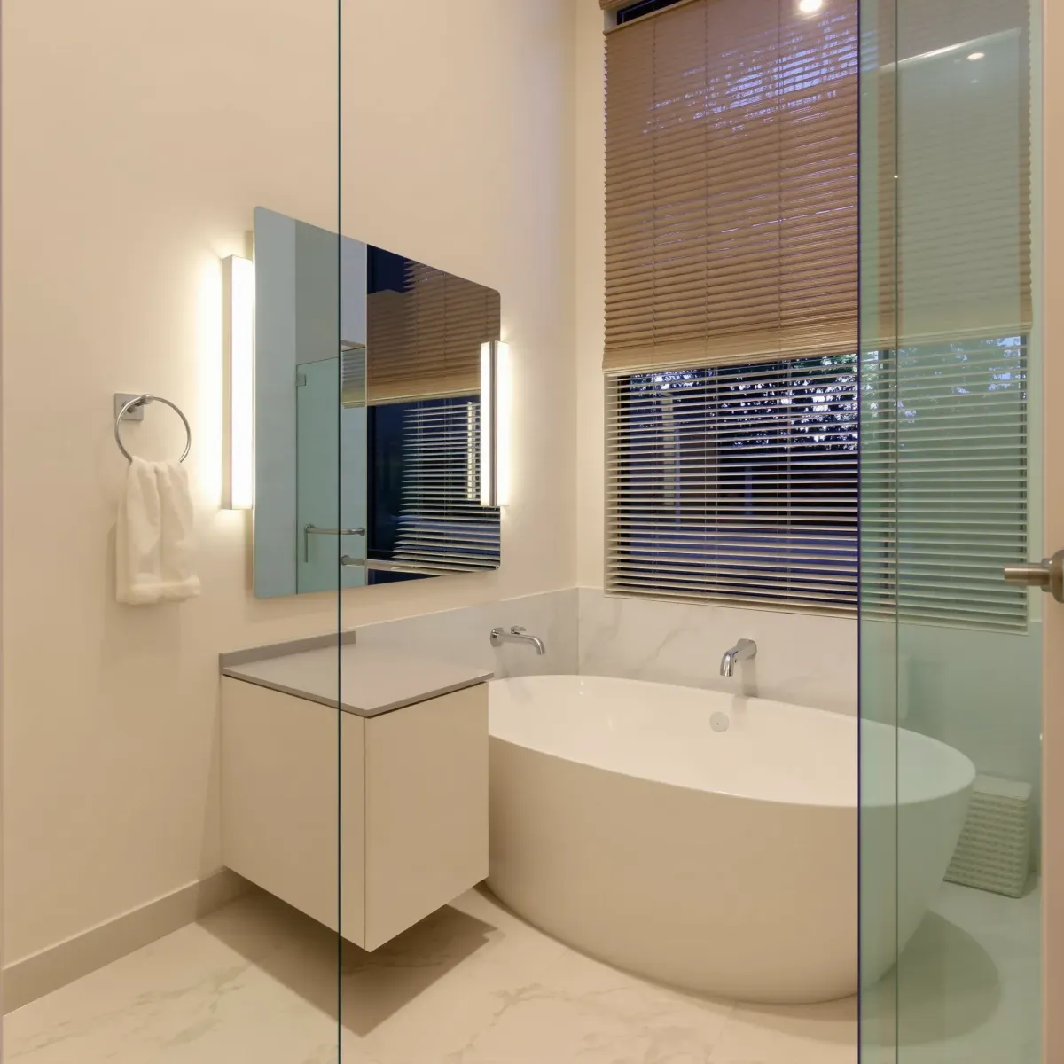 Modern Mid Wilshire bathroom with sleek fixtures, tiled walls, glass shower, and elegant lighting design.