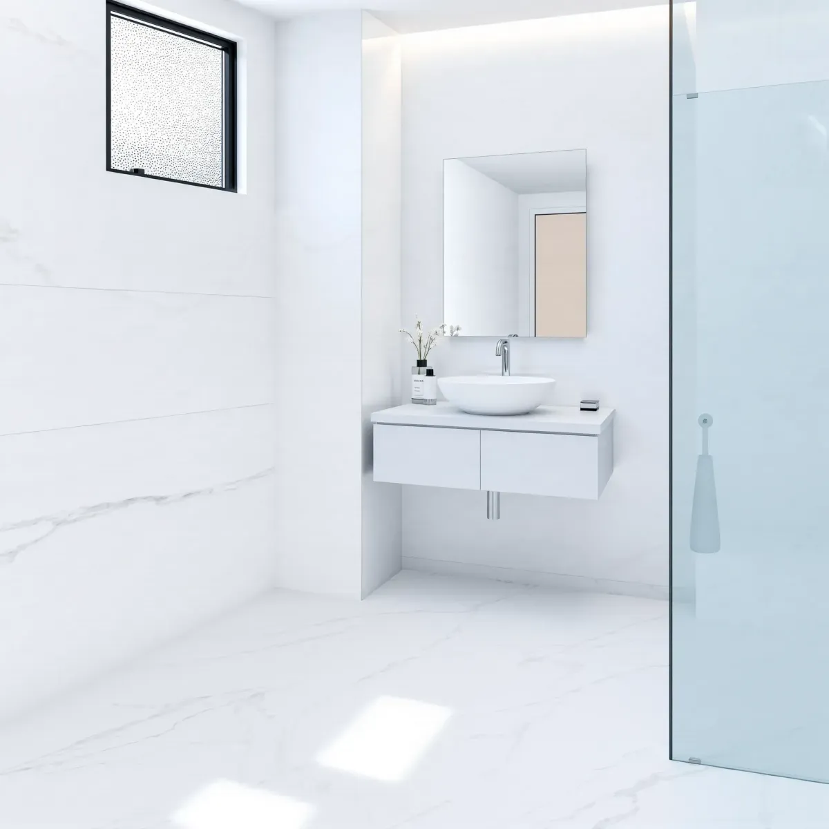 Renovated small bathroom in Jefferson Park, CA with white marble tiles, glass shower, floating vanity, and natural light.