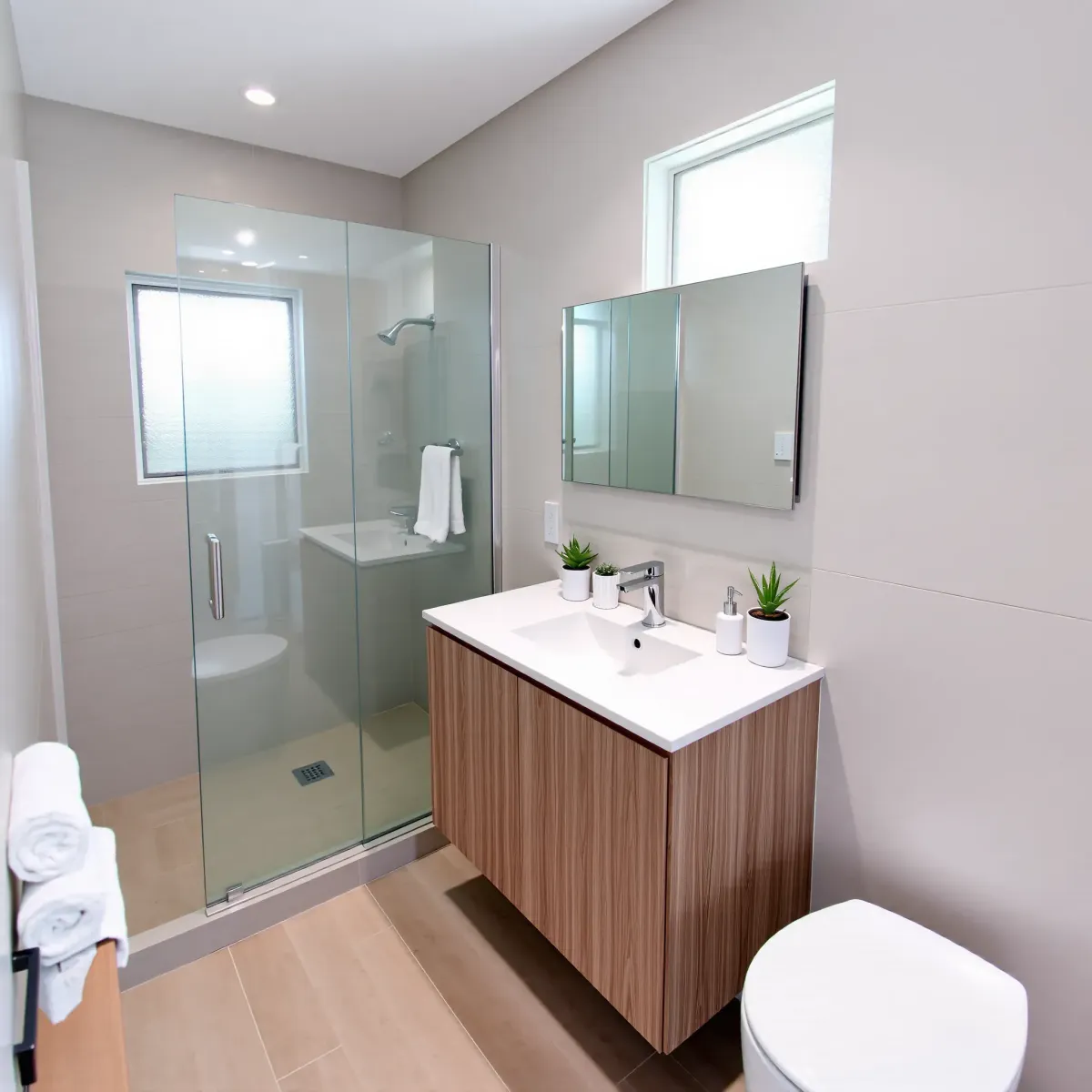Remodeled small Carson, CA bathroom with modern fixtures, marble vanity, vessel sink, glass shower, and sleek design.