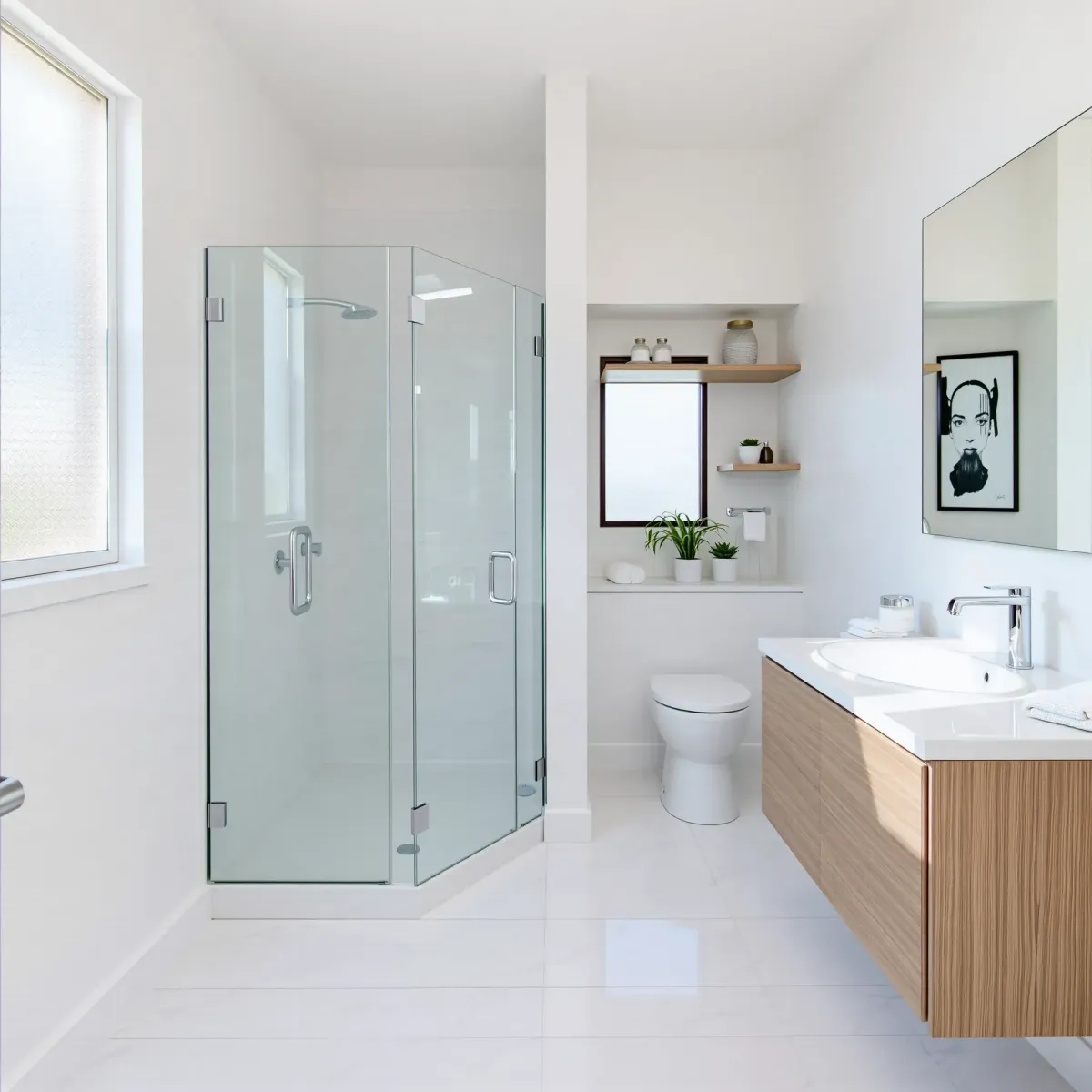 Remodeled small Rancho Park bathroom with modern fixtures, marble floors, glass shower, sleek vanity, and natural light.