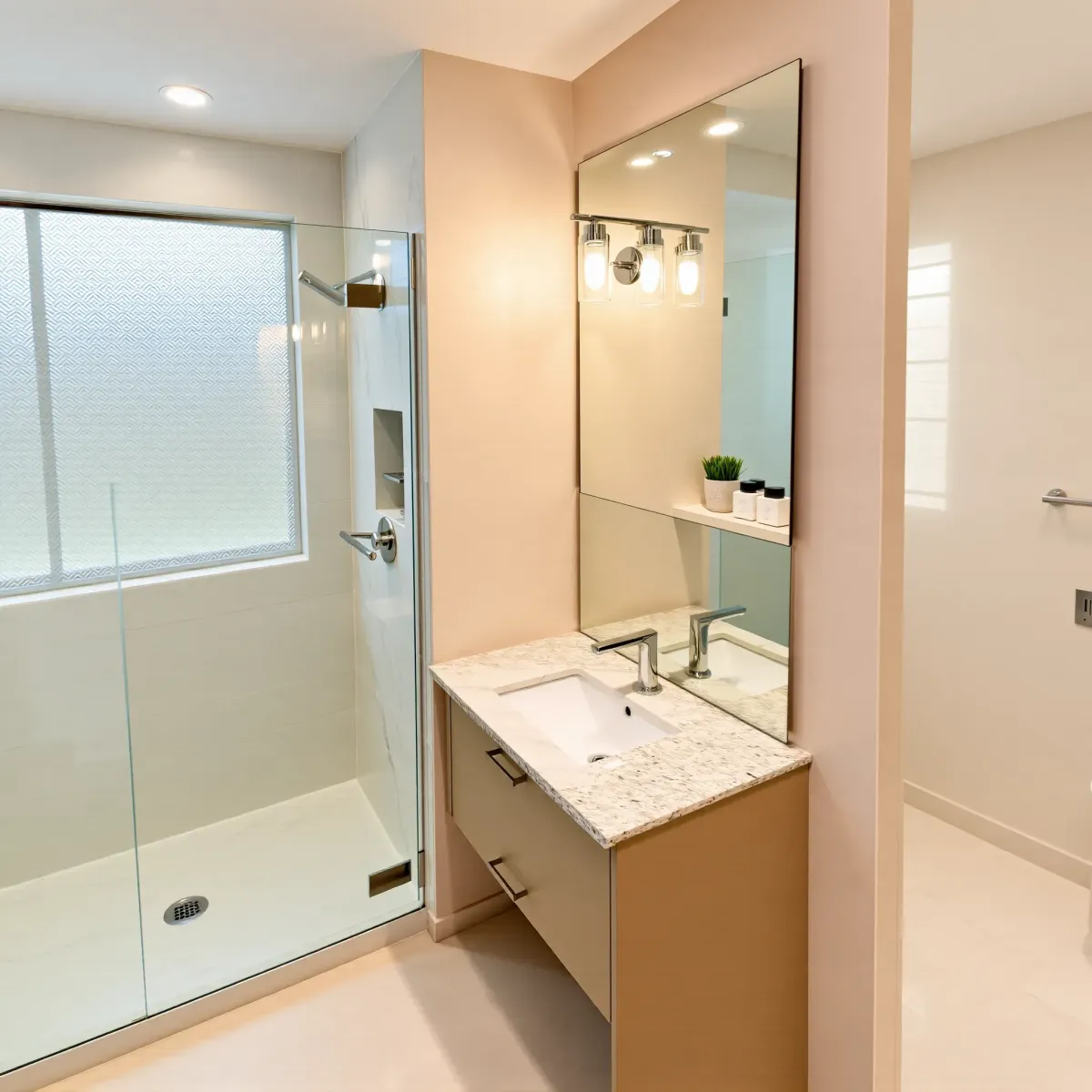Remodeled small bathroom in Lawndale, CA featuring modern design, marble vanity, glass shower, natural light, and sleek finishes.