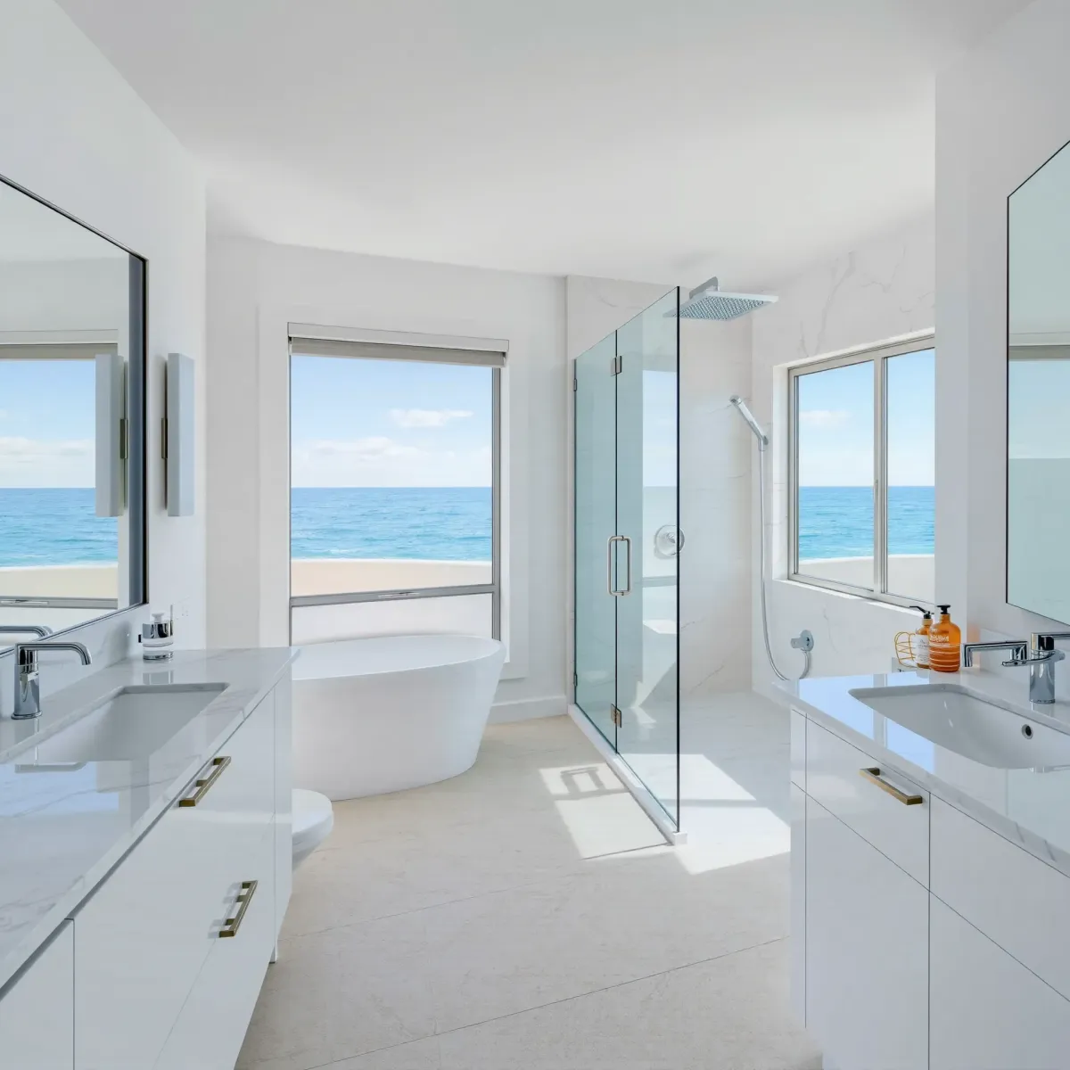Beautiful remodeled Hermosa Beach bathroom with walk-in shower, freestanding tub, coastal decor, and ocean view windows.