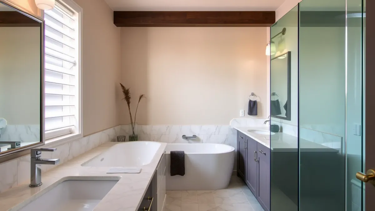 Modern renovated Hawthorne bathroom with marble countertops, glass shower, soaking tub, and sleek cabinetry.
